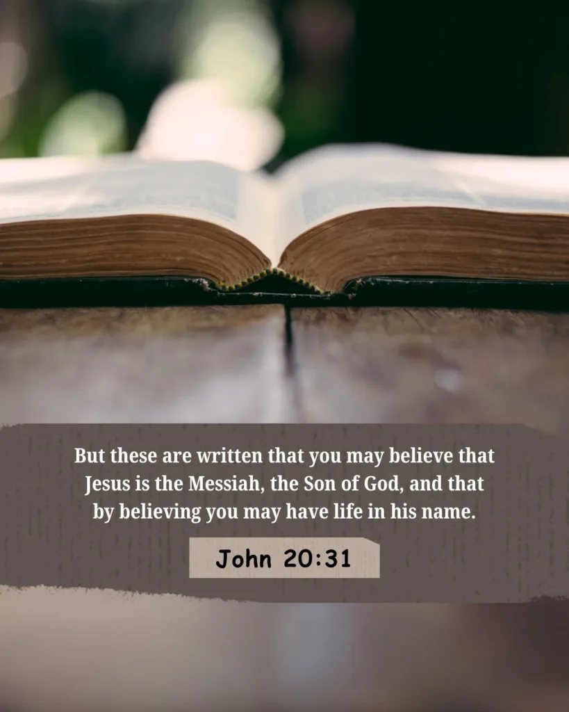 John 20:31 Bible verse artwork featuring an open Bible with the scripture, “But these are written that you may believe that Jesus is the Messiah, the Son of God, and that by believing you may have life in his name,” presented with clean typography and a peaceful background.