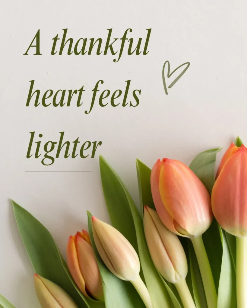 Inspirational gratitude quote with soft peach tulips and green leaves featuring the message, "A thankful heart feels lighter," symbolizing peace, joy, and thankfulness.